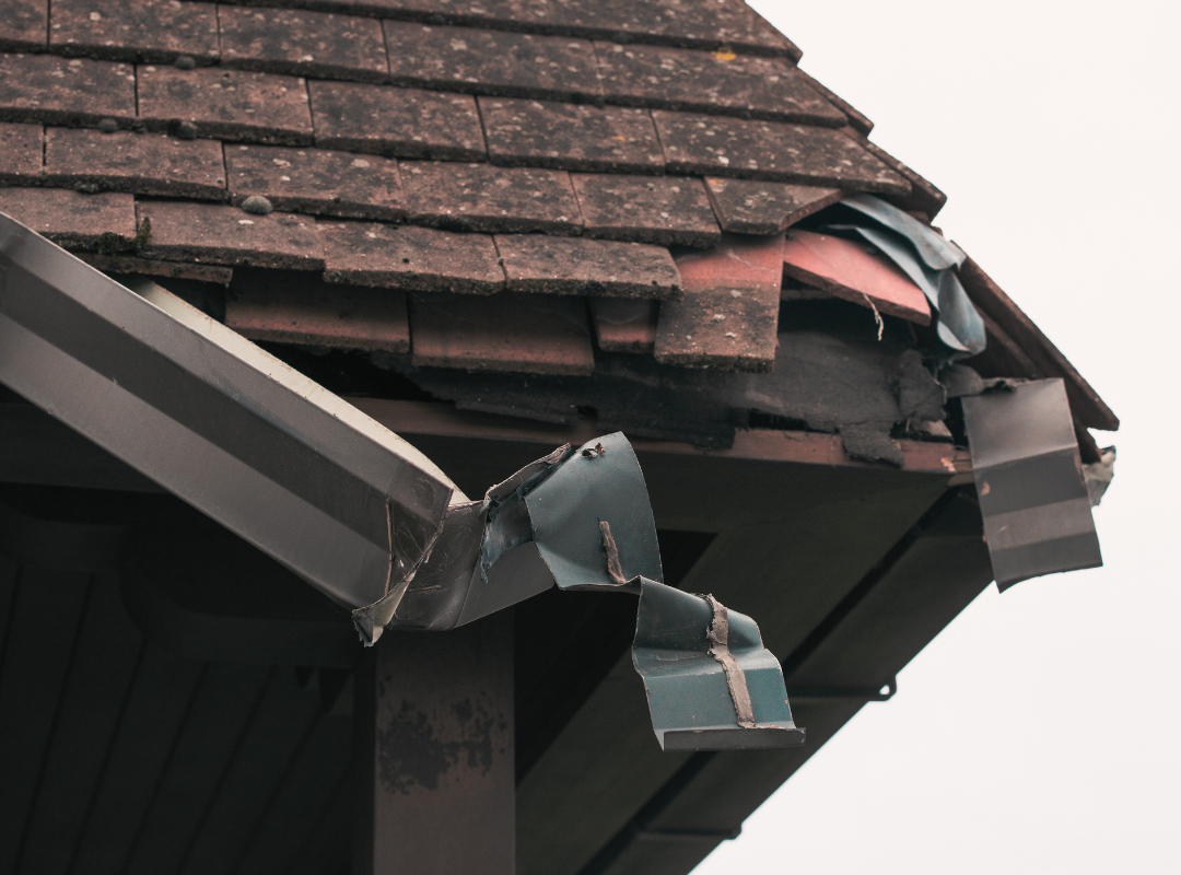 Property that needs repairs - broken roof guttering and missing tiles