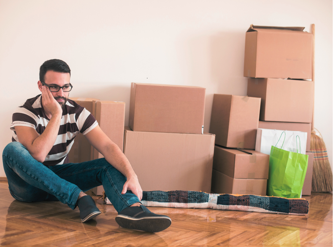 Selling after a divorce - man sitting amongst removal boxes