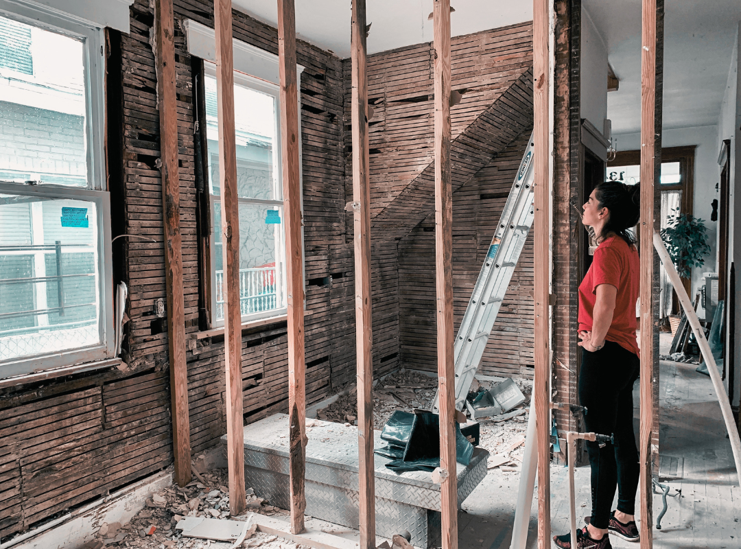 As-Is - woman assessing an internal wall repair